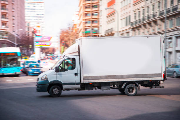 Delivery van in motion A delivery man in motion delivery van stock pictures, royalty-free photos & images